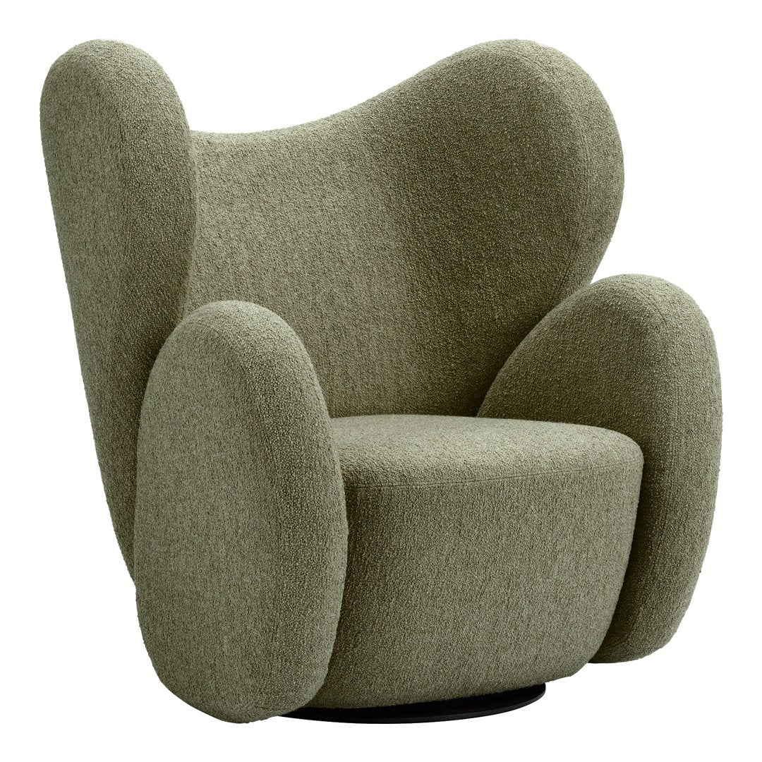 Curved green upholstered armchair with a textured fabric and soft, rounded shapes, offering a cozy aesthetic.