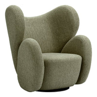 Curved green upholstered armchair with a textured fabric and soft, rounded shapes, offering a cozy aesthetic.