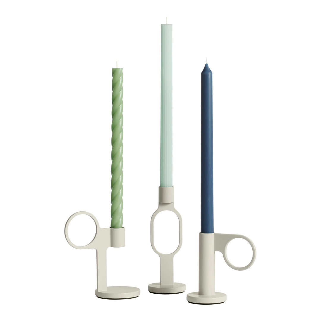 "Set of three elegant candle holders with twisted green, light blue, and dark blue candles against a neutral backdrop."