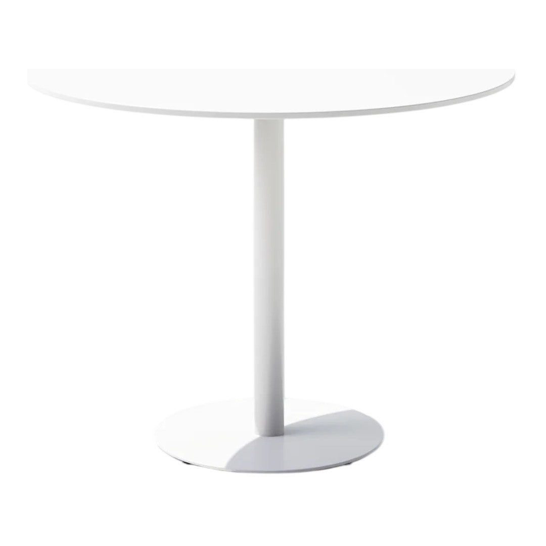 Round white dining table with a sleek base, featuring a minimalist design and smooth surface texture.
