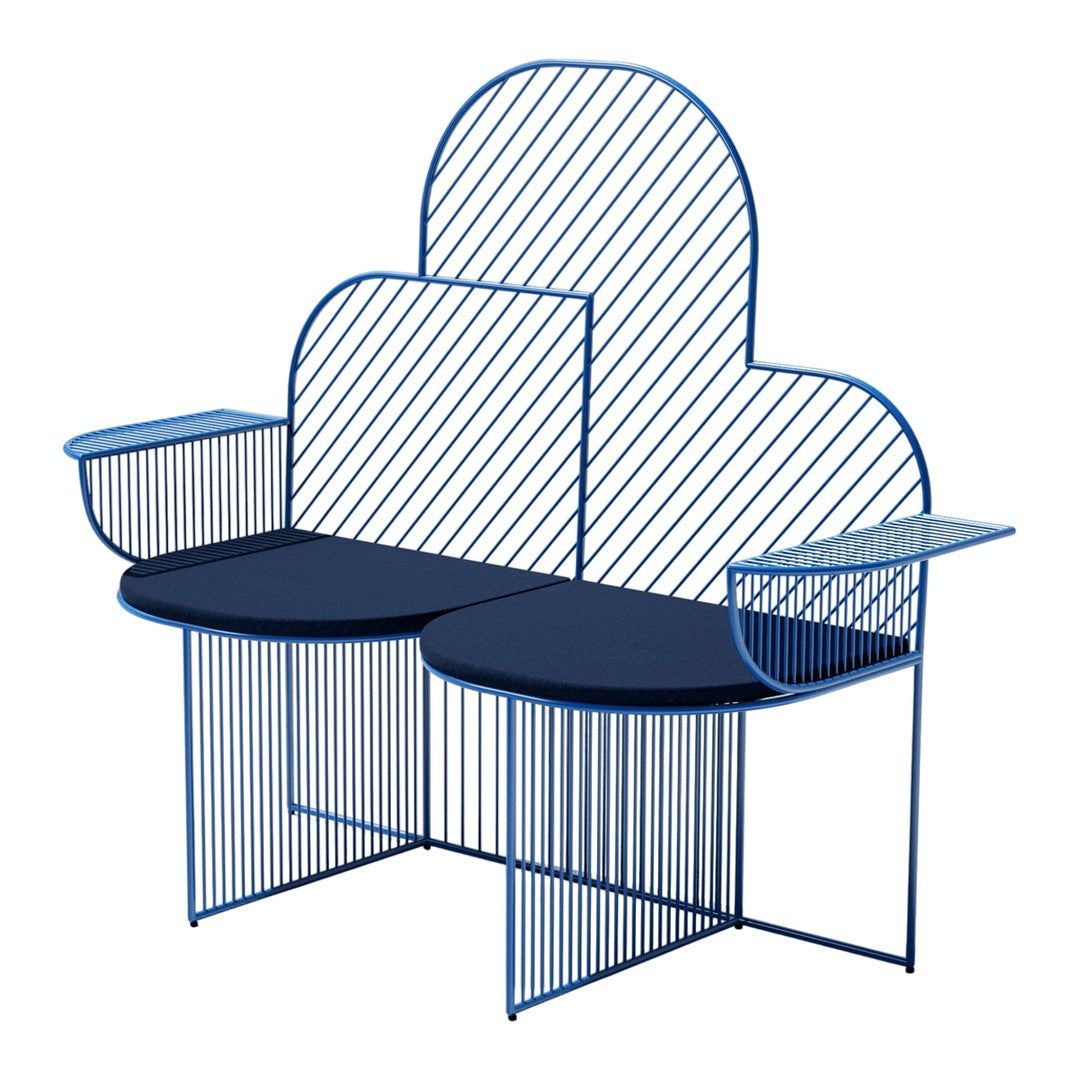 Blue metal bench with a cloud shape, featuring striped backrest and circular seat patterns. Modern design aesthetic.