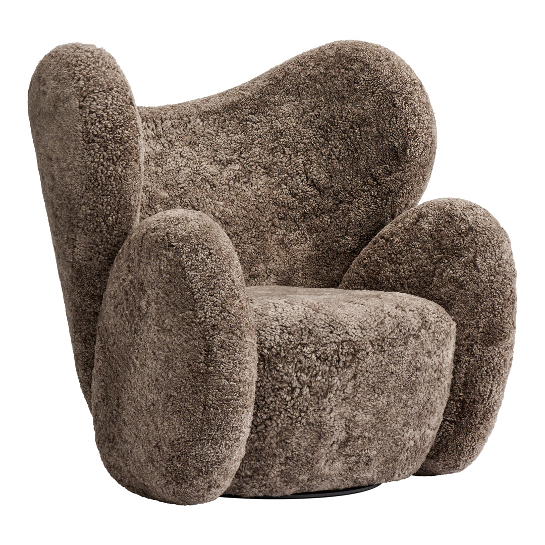 Textured brown plush chair with rounded armrests and a unique, modern silhouette. Perfect for cozy spaces.