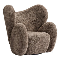 Textured brown plush chair with rounded armrests and a unique, modern silhouette. Perfect for cozy spaces.