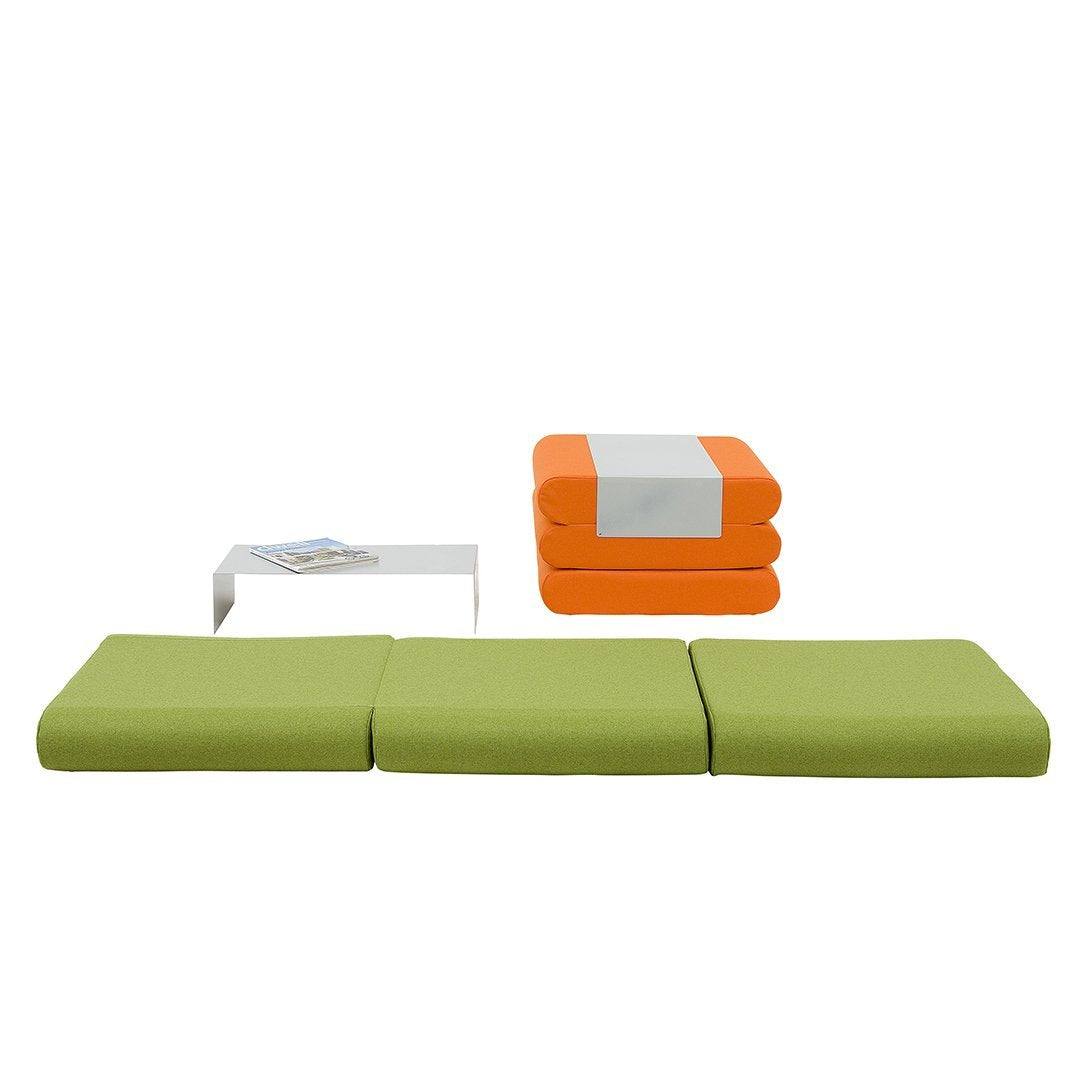 Green outdoor cushions with vibrant orange and white stackable cushions, and a sleek white table.