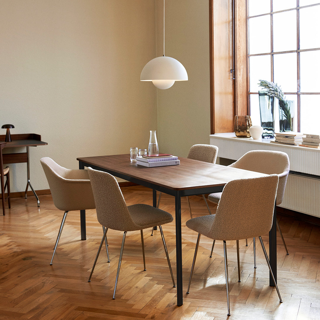 Modern dining set with beige chairs, dark wood table, and warm tones, complemented by minimalist lighting and natural wood flooring.