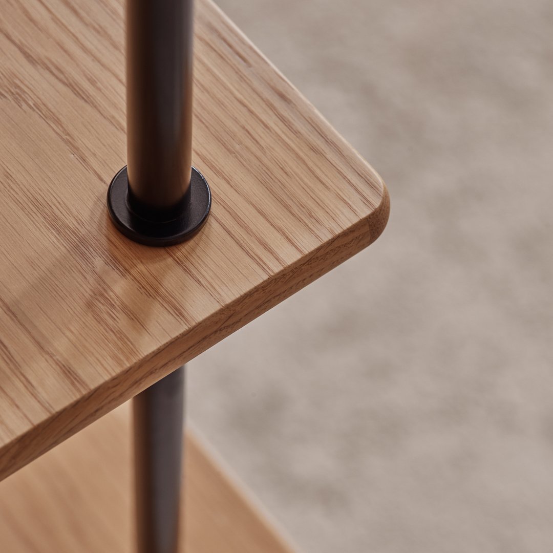 Wooden shelf with light oak finish and sleek black metal accents, showcasing natural grain patterns.