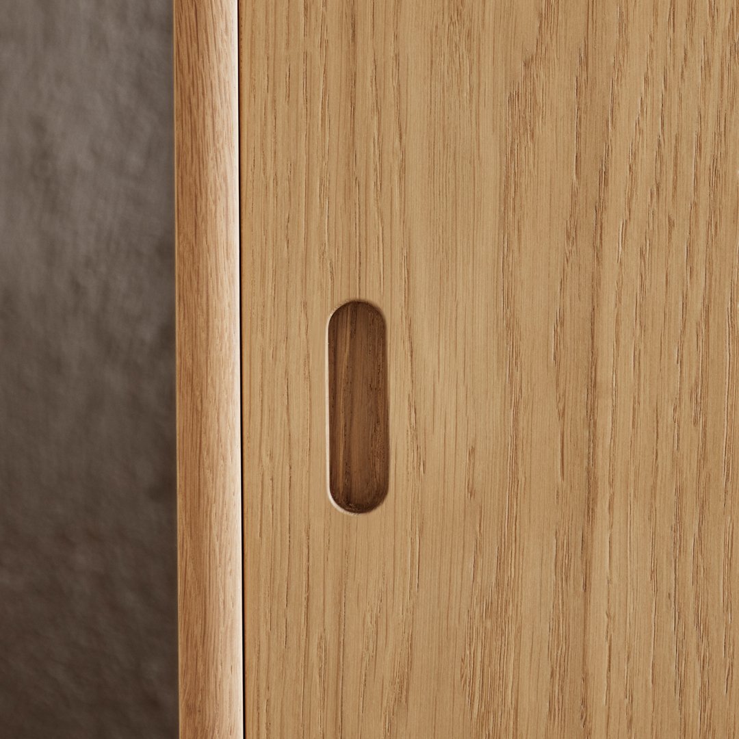 Light wood grain texture with a smooth finish and a sleek, minimalist design featuring a simple cutout handle.