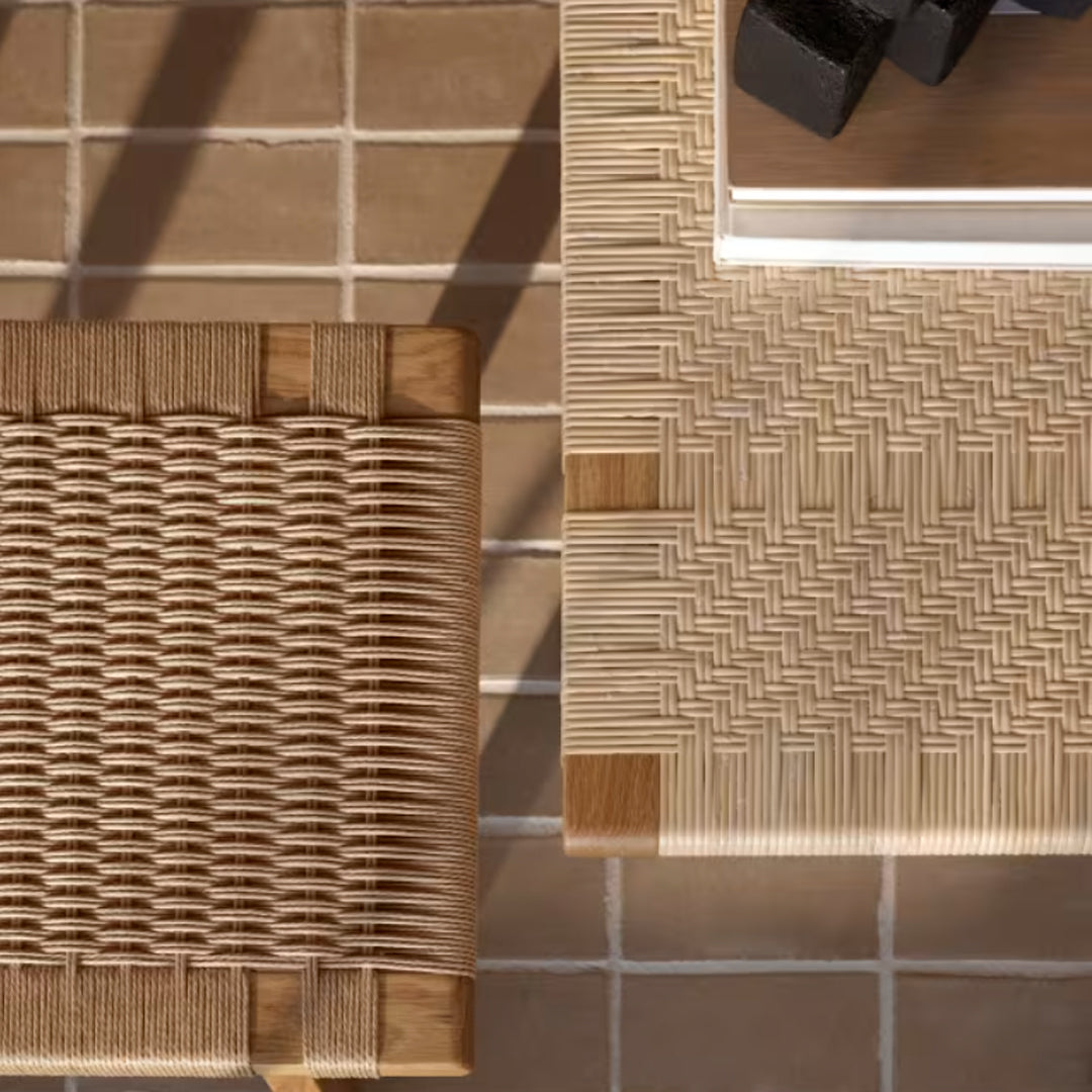 Natural beige and light brown woven patterns on wood and rattan surfaces, set on a neutral tiled background.