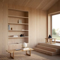 Light wood shelving with minimalist design in a bright, natural light setting, featuring neutral tones and soft textures.