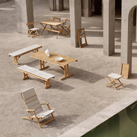Natural wood hues with white slatted patterns in outdoor furniture set against a minimalist stone backdrop.