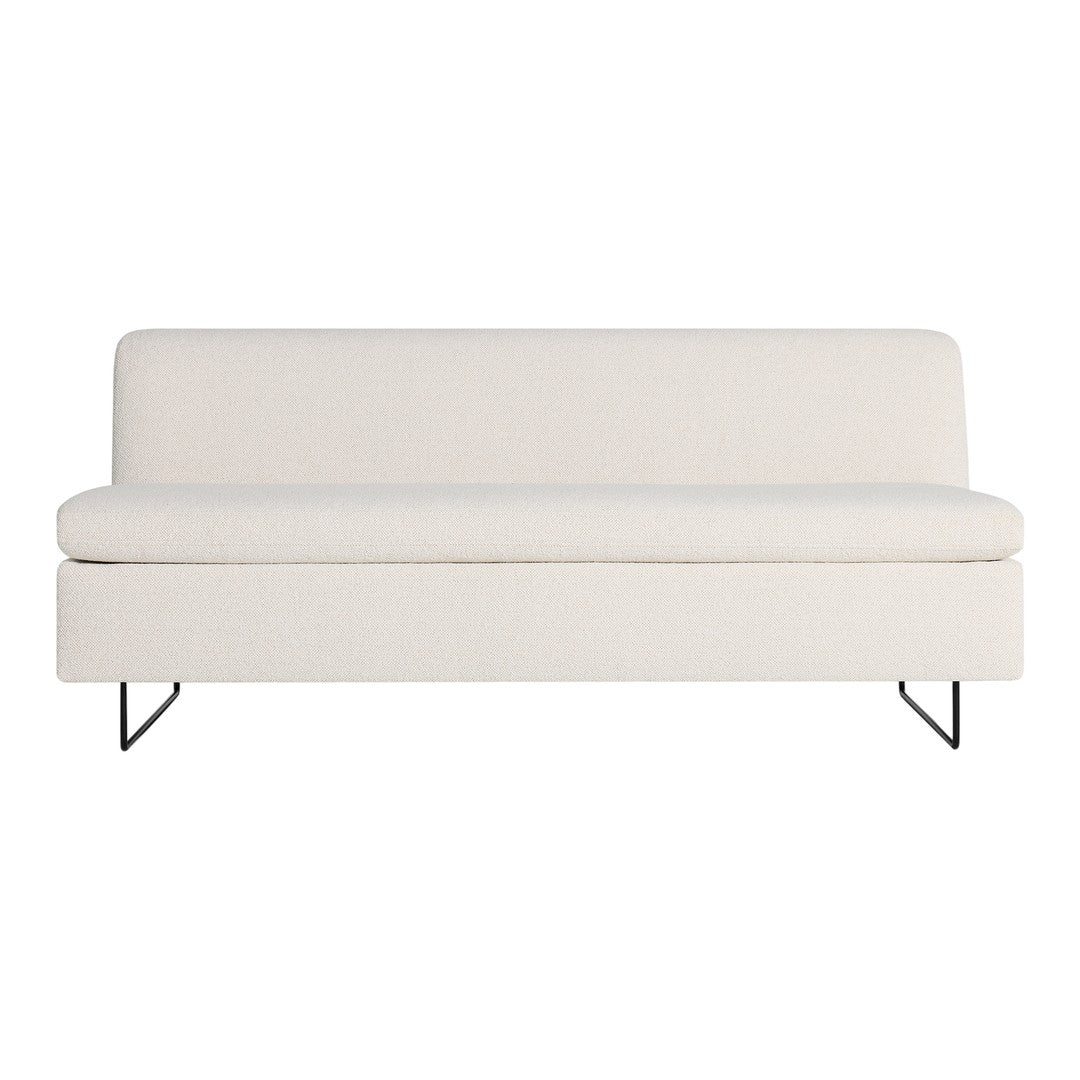 Cream-colored sofa with a soft texture and minimalist design, complemented by sleek black metal legs.