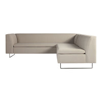 Beige L-shaped sofa with a minimalist design and smooth fabric texture, set on sleek metal legs.
