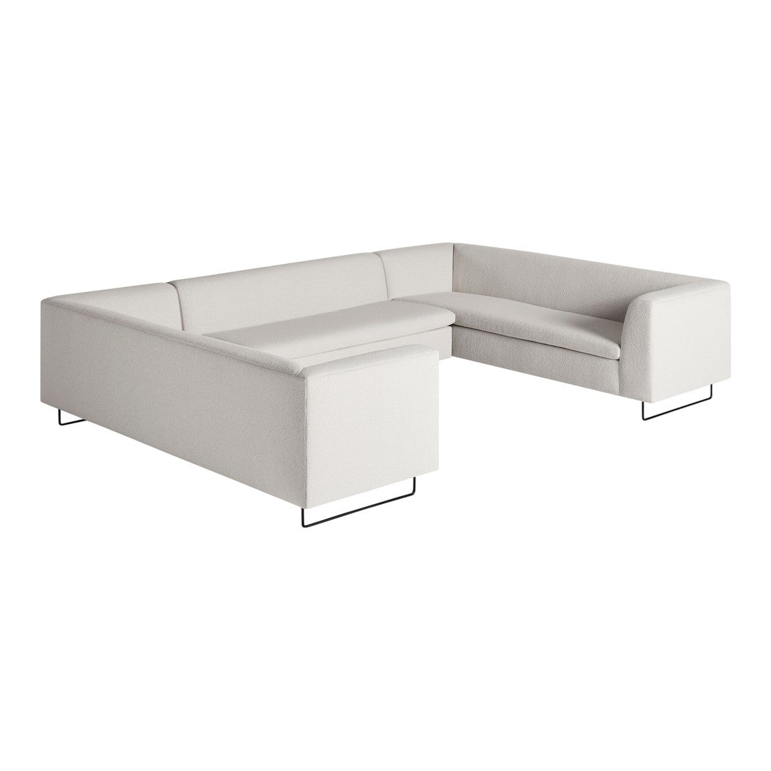 Modern sectional sofa in soft beige fabric with clean lines and minimalist black metal legs. Perfect for contemporary decor.