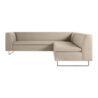 Beige corner sofa with a smooth texture and minimalist design, featuring clean lines and metal legs. Perfect for modern decor.