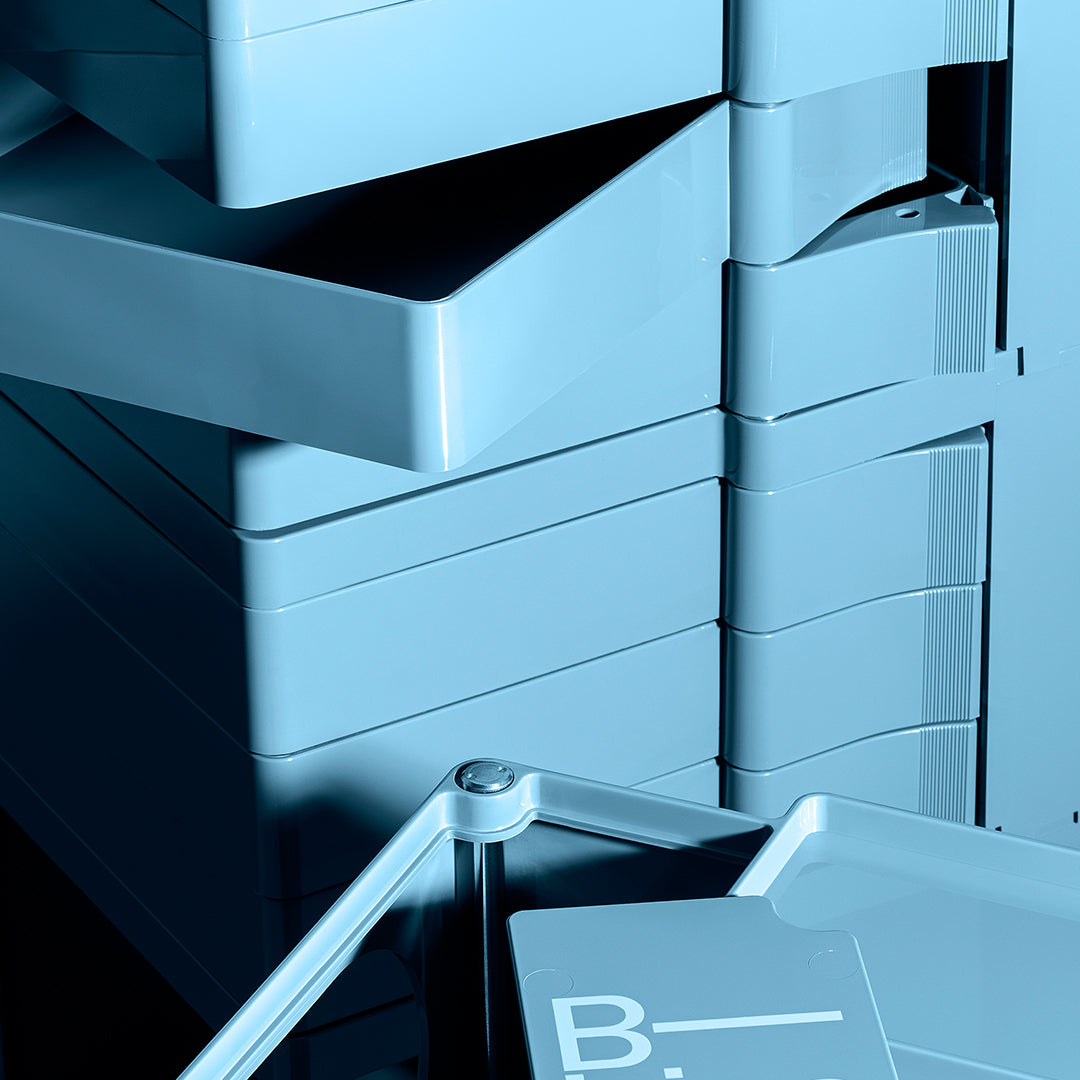 Stacked storage bins in a soft blue shade, featuring sleek, modern lines and glossy surfaces.