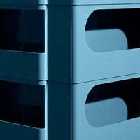 Stacked blue storage bins with smooth edges and cut-out handles, showcasing a modern, minimalist design.
