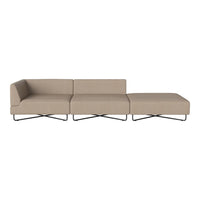 Beige sectional sofa with a minimalist design and smooth, contemporary lines, resting on sleek metal legs.