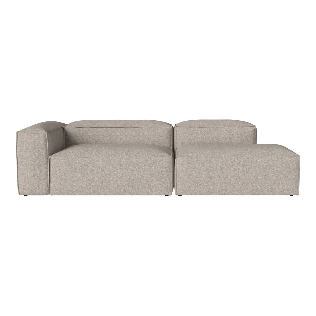 Beige sectional sofa with a minimalist design, featuring clean lines and a sleek, modern finish.
