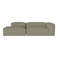Olive green modular sofa with a contemporary, minimalist design and clean lines. Soft, textured fabric upholstery.