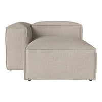 Beige textured chaise lounge with a smooth, minimalist design and subtle, neutral color palette.