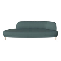 Curved teal sofa with a smooth texture and light wooden legs. Modern design for stylish interiors.