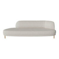Light beige curved sofa with a smooth texture and minimalist design, featuring natural wood legs.