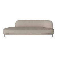 Beige curved sofa with a smooth, minimalist design and subtle texture on a sleek metal base. Ideal for contemporary decor.