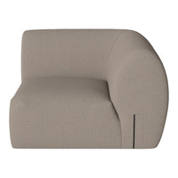 Curved beige sofa with a soft textured fabric, showcasing minimalistic design and modern aesthetic.