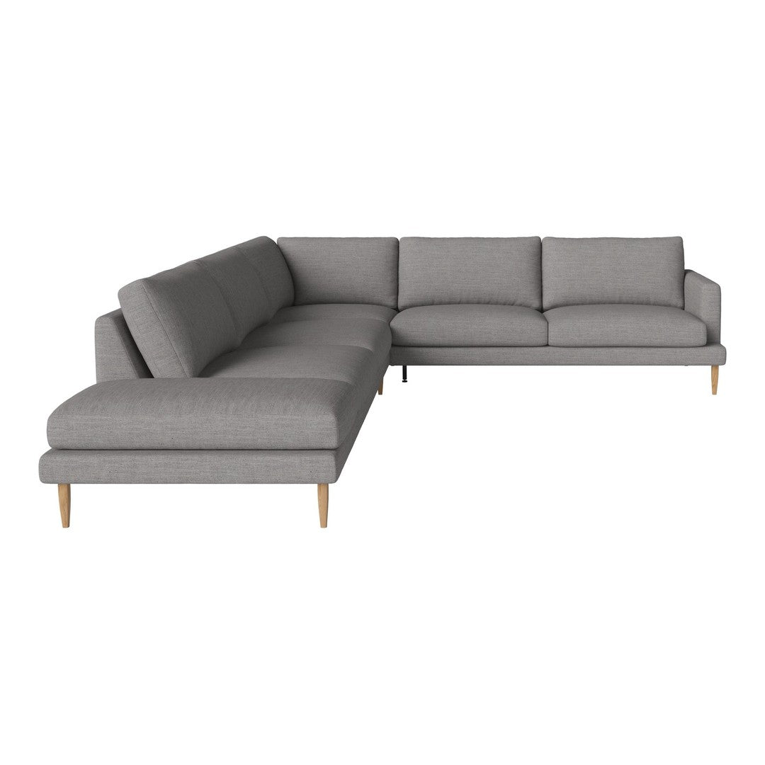 Gray sectional sofa with a modern, minimalist design and soft fabric upholstery, featuring natural wood legs.