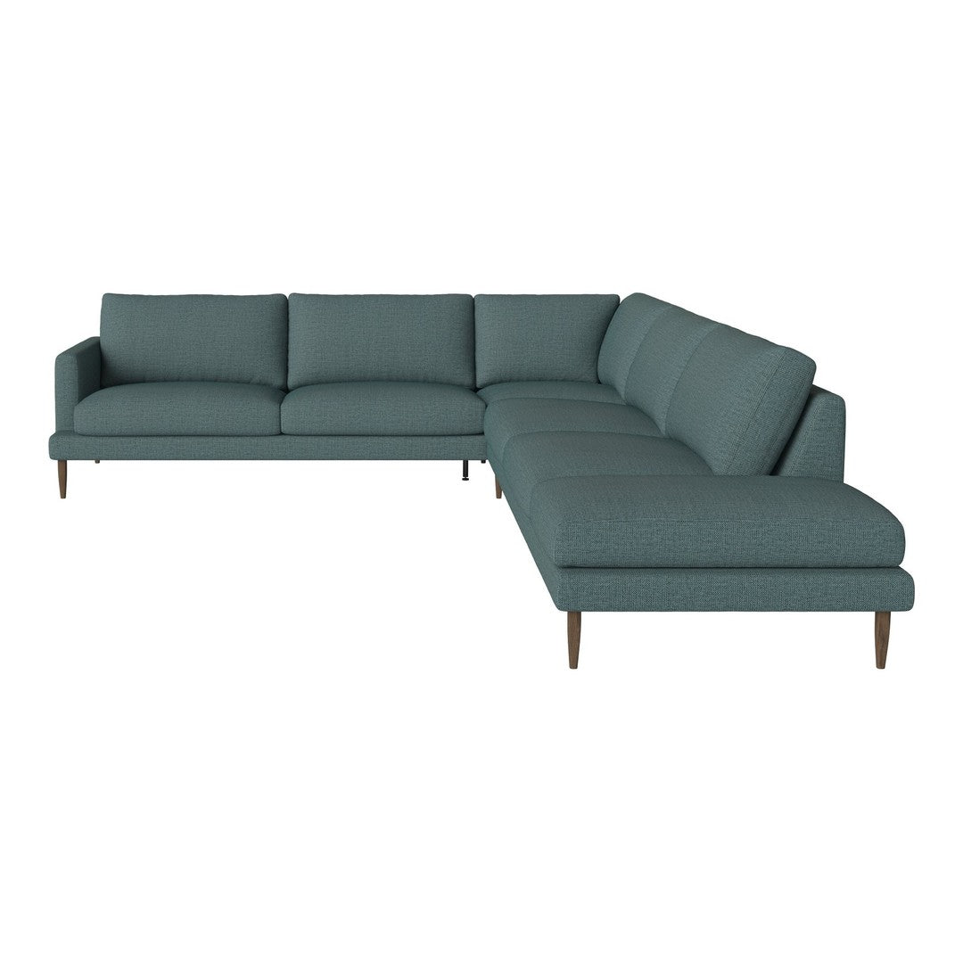 Teal sectional sofa with a textured pattern and minimalist design, featuring tapered brown wooden legs.
