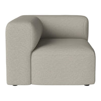 Beige fabric corner chair with a smooth, modern design and rounded edges. Perfect for contemporary decor.