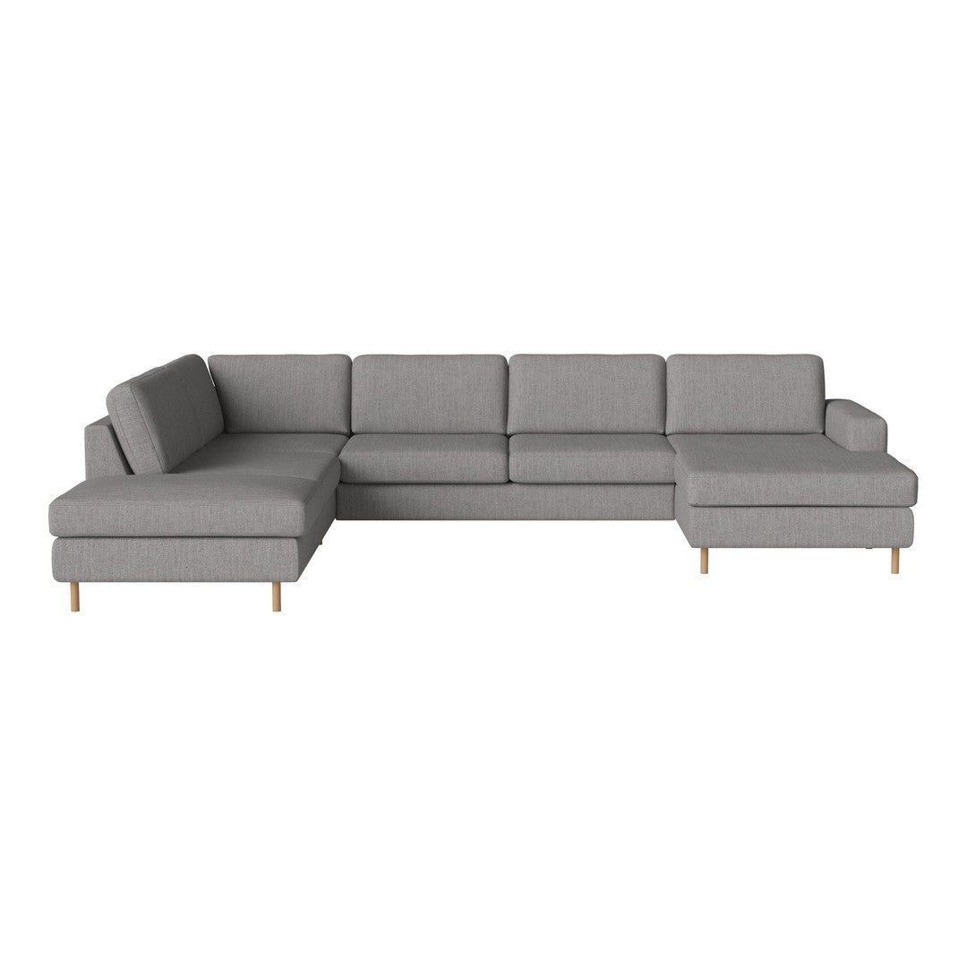 "Modern sectional sofa in soft gray fabric with clean lines and a minimalist design, featuring light wood legs."