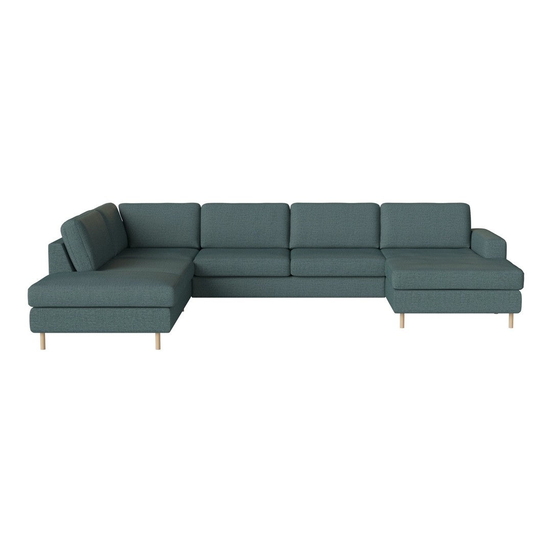 Teal sectional sofa with a modern design, featuring clean lines and soft upholstery, complemented by natural wood legs.