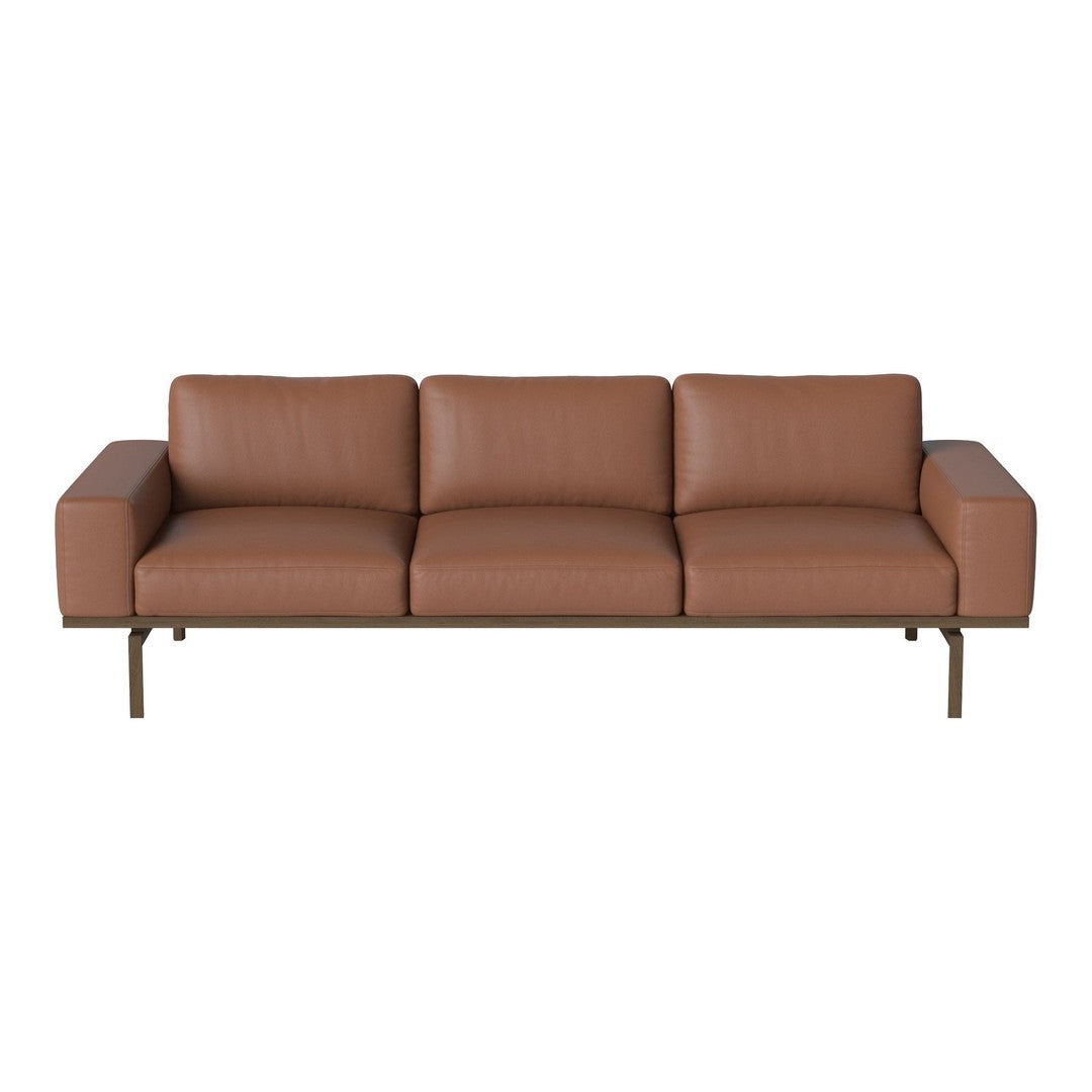 Brown leather sofa with a sleek design and clean lines, featuring subtle texture and a modern, minimalist aesthetic.