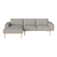 Light gray sectional sofa with a smooth, textured fabric and minimalist wooden legs. Perfect for modern living spaces.