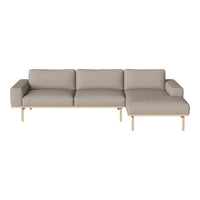 Light grey upholstered sofa with a minimalist design and natural wood legs, featuring a clean, modern aesthetic.