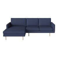 Navy blue sectional sofa with solid cushions and natural wood legs, offering a modern and minimalist design.