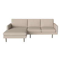 Beige sectional sofa with clean lines and minimalistic design, featuring light upholstery and sleek metal legs.
