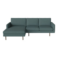 Teal upholstered sectional sofa with smooth, modern lines and light wooden legs, perfect for contemporary spaces.