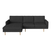 Dark gray sectional sofa with a minimalist design and light wood legs. Ideal for modern living spaces.