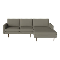 Stylish gray sectional sofa with clean lines and a minimalist design, featuring smooth fabric and wooden legs.