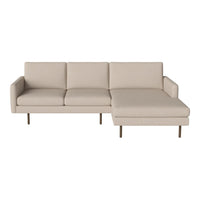 Beige sectional sofa with a minimalist design and smooth upholstery, featuring clean lines and sleek metal legs.
