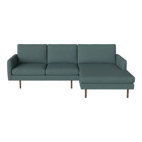 Teal fabric sectional sofa with clean lines and minimalist design, featuring solid wood legs and a modern aesthetic.