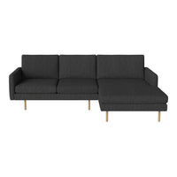Modern dark gray fabric sofa with clean lines and wooden legs, featuring a minimalist design and chic style.