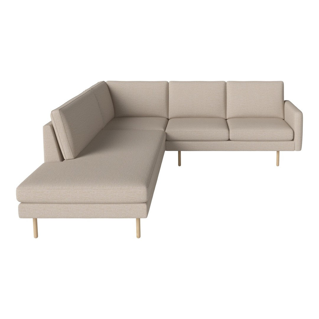 Beige sectional sofa with clean lines and minimalist design, featuring a smooth fabric surface and light wood legs.