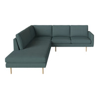 Teal sectional sofa with a modern design and subtle textured pattern, featuring light wooden legs.