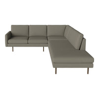 Modern sectional sofa in soft grey upholstery with clean lines and minimalist design, featuring subtle, sleek textures.
