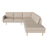 Beige sectional sofa with clean lines and light wood legs, offering a modern minimalist design.