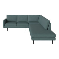 Teal sectional sofa with a modern design and clean lines, featuring a textured fabric on minimalist black legs.
