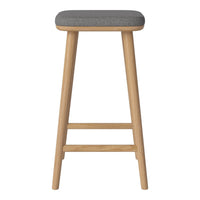 Gray upholstered stool with natural wood legs, featuring a sleek, minimalist design. Perfect for modern decor.